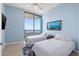 Bright bedroom featuring hardwood floors, ceiling fan, balcony access, and two beds for flexible accommodations at 1560 Gulf Blvd # 1202, Clearwater Beach, FL 33767