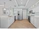 Well-lit kitchen with white cabinets, stainless steel appliances, and stylish flooring at 1560 Gulf Blvd # 1202, Clearwater Beach, FL 33767