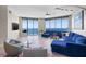 Bright living room with floor-to-ceiling windows offering ocean views, and comfortable seating at 1560 Gulf Blvd # 1202, Clearwater Beach, FL 33767