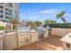 Built-in outdoor kitchen features stainless steel appliances for gourmet grilling at 1560 Gulf Blvd # 1202, Clearwater Beach, FL 33767