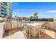 Outdoor kitchen featuring stone counters, stainless steel appliances, and barstool seating at 1560 Gulf Blvd # 1202, Clearwater Beach, FL 33767