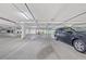 Well-lit parking garage with parking spots and visible signage at 1560 Gulf Blvd # 1202, Clearwater Beach, FL 33767