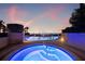 Inviting outdoor pool and jacuzzi offer relaxation with scenic ocean views during a colorful sunset at 1560 Gulf Blvd # 1202, Clearwater Beach, FL 33767