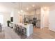 Modern kitchen features an island with seating, stainless steel appliances, and pendant lighting at 16388 Cape Horn Blvd, Punta Gorda, FL 33955