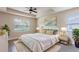 Inviting bedroom with a tray ceiling, a ceiling fan and natural light at 16388 Cape Horn Blvd, Punta Gorda, FL 33955