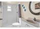 Neat bathroom with a white-tiled shower and white fixtures at 1662 S Lake Ave # 2, Clearwater, FL 33756