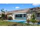 Exterior shot of a home with well-maintained grass, a patio, and an awning over the entry way at 1662 S Lake Ave # 2, Clearwater, FL 33756