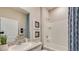 Well-lit bathroom with vanity, framed mirror, and a shower-tub combination with a white tile surround at 17061 James Trl, Parrish, FL 34219