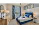 Cozy bedroom with large window, stylish decor, a comfortable bed and bedside table lamps at 17061 James Trl, Parrish, FL 34219