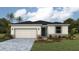 Charming single-story home with well-maintained landscaping, two car garage, and stone accents at 17061 James Trl, Parrish, FL 34219