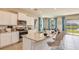 Bright, modern kitchen features granite countertops, stainless appliances, and a spacious island with seating at 17061 James Trl, Parrish, FL 34219
