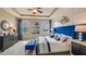 Spacious main bedroom with a large bed, neutral walls, and a bench at 17061 James Trl, Parrish, FL 34219