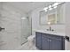 Bathroom featuring marble walls, a glass-enclosed shower, and a vanity with a sink and mirror at 1801 N Morgan St # 6, Tampa, FL 33602