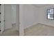 The bedroom offers light wood floors and a black-trimmed window with natural light at 1801 N Morgan St # 6, Tampa, FL 33602