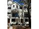 Beautiful townhome with a modern white exterior, black trim and railing details, and a well-kept yard at 1801 N Morgan St # 6, Tampa, FL 33602