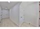 A hallway with light wood floors and white walls, with multiple doorways at 1801 N Morgan St # 6, Tampa, FL 33602