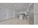 Spacious open floor plan with a kitchen including stainless steel appliances, white cabinets, and an island at 1801 N Morgan St # 6, Tampa, FL 33602