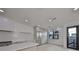 A modern kitchen features white cabinets, stainless steel appliances, and an island with a white countertop at 1801 N Morgan St # 6, Tampa, FL 33602