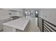 Modern open-concept kitchen featuring a central island, white cabinets, and wood flooring at 1801 N Morgan St # 6, Tampa, FL 33602