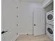 Bright laundry room features a stacked washer and dryer, and modern white doors at 1801 N Morgan St # 6, Tampa, FL 33602