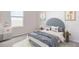 Bright bedroom featuring a grey upholstered headboard, neutral walls and modern decor at 1812 Cobb Trl, Parrish, FL 34219