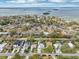 Scenic aerial view of waterfront homes with mature trees, blue skies, and ocean view at 1868 Douglas Ave, Dunedin, FL 34698