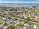 Scenic aerial view of homes with mature trees, blue skies, and ocean view at 1868 Douglas Ave, Dunedin, FL 34698