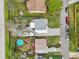 Aerial view of backyards with pools, patios, and recreational vehicles in a residential neighborhood at 1868 Douglas Ave, Dunedin, FL 34698