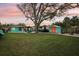 Spacious backyard features a lush lawn, shed and mature trees, perfect for outdoor enjoyment and entertaining at 1868 Douglas Ave, Dunedin, FL 34698