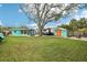 Large backyard with a shed, patio area, and well-maintained lawn for outdoor enjoyment at 1868 Douglas Ave, Dunedin, FL 34698