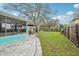 Expansive backyard features lush lawn, stone walkway, privacy fence and room for outdoor activities at 1868 Douglas Ave, Dunedin, FL 34698