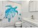 Clean bathroom with a turtle-themed shower curtain, white subway tile, and modern sink at 1868 Douglas Ave, Dunedin, FL 34698