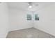 Neutral bedroom featuring two windows, a ceiling fan, and calming decor for a serene retreat at 1868 Douglas Ave, Dunedin, FL 34698