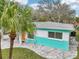 Colorful home exterior, with a landscaped yard, modern hardscape, and a welcoming curb appeal at 1868 Douglas Ave, Dunedin, FL 34698