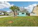 Landscaped front yard showcasing vibrant green grass and a neatly maintained exterior at 1868 Douglas Ave, Dunedin, FL 34698