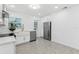 Modern kitchen boasts stainless steel appliances, a farmhouse sink, and stylish cabinets, perfect for culinary enthusiasts at 1868 Douglas Ave, Dunedin, FL 34698