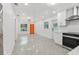Bright open floorplan showcasing the living room and kitchen, with modern finishes and stainless steel appliances at 1868 Douglas Ave, Dunedin, FL 34698