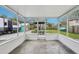 Bright and airy screened in porch with views of the landscaped backyard at 1868 Douglas Ave, Dunedin, FL 34698