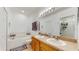 Bright bathroom featuring double sinks, a soaking tub, and a separate glass-enclosed shower at 18822 Quarry Badger Rd, Land O Lakes, FL 34638
