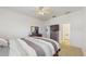 Bedroom featuring carpeted floors, a ceiling fan, and furnished with a dresser and a mounted television at 18822 Quarry Badger Rd, Land O Lakes, FL 34638