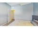 Bedroom featuring light blue walls, carpeted floor and an open door to another room at 18822 Quarry Badger Rd, Land O Lakes, FL 34638
