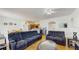 Open living area with wood floors, comfortable seating, and views into dining area at 18822 Quarry Badger Rd, Land O Lakes, FL 34638