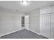 This bedroom features neutral walls, carpeted flooring, and a closet for storage at 1915 Meridel Ave, Tampa, FL 33612