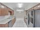 Bright, modern kitchen featuring granite countertops, dark wood cabinetry, and stainless steel appliances at 1915 Meridel Ave, Tampa, FL 33612