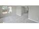 Open-concept room with tile flooring, large windows, and view of dining area at 1915 Meridel Ave, Tampa, FL 33612