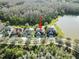 This aerial view highlights the home's position among mature trees and a tranquil pond at 19238 Climbing Aster Dr, Tampa, FL 33647