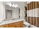 Well-lit bathroom features granite countertop, large mirror, and neutral tile accents at 19238 Climbing Aster Dr, Tampa, FL 33647