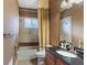 Bathroom featuring shower, vanity, dark granite countertop, and a framed mirror at 19238 Climbing Aster Dr, Tampa, FL 33647