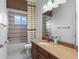 This bathroom features a shower and tub combination with a nice mirror and vanity at 19238 Climbing Aster Dr, Tampa, FL 33647