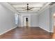 Bedroom with coffered ceiling, neutral colors and hardwood floors at 19238 Climbing Aster Dr, Tampa, FL 33647